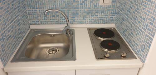 a kitchen with a sink and a stove at ele&gio accomodation in Tropea
