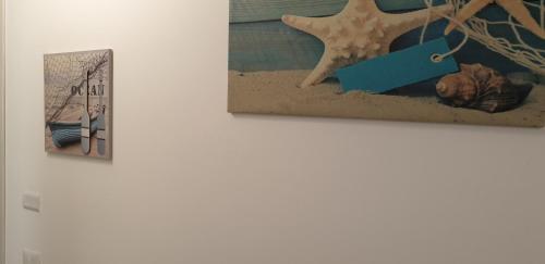 two pictures hanging on a wall in a museum at ele&gio accomodation in Tropea