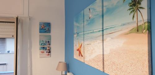 a blue wall with a picture of a beach at ele&gio accomodation in Tropea