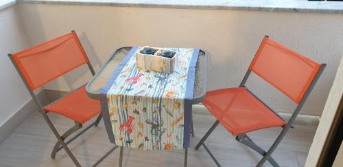 a table with two chairs and a bag on it at ele&gio accomodation in Tropea