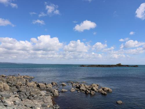a large group of rocks in the water at Wootton Gray in Mousehole