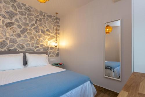 a bedroom with a bed and a mirror at Rapanos Apartments in Paleokastritsa