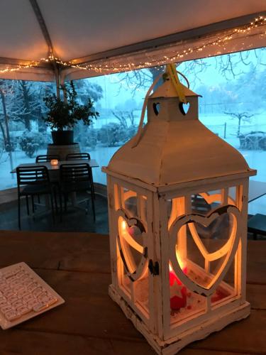a lantern with a candle in it on a table at Agriturismo Regusci in Camorino