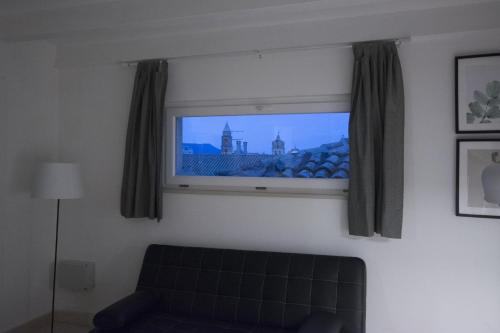 a television in a living room with a couch at Palazzo di Fazio Suites in San Severo