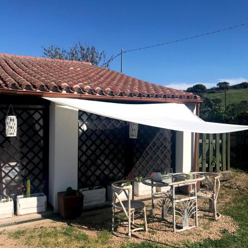 a white canopy over a table and chairs at B&B La Tasgia in Aggius