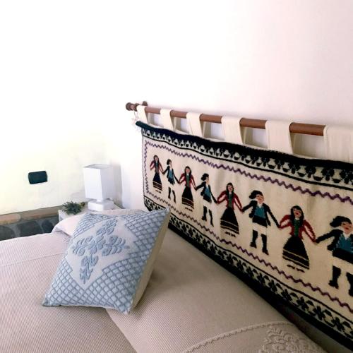 a bedroom with a bed with a large pillow on it at B&B La Tasgia in Aggius