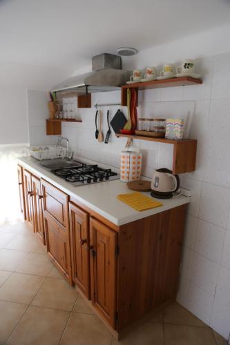 a kitchen with a stove and a counter top at Fruit'n Joy in Stresa