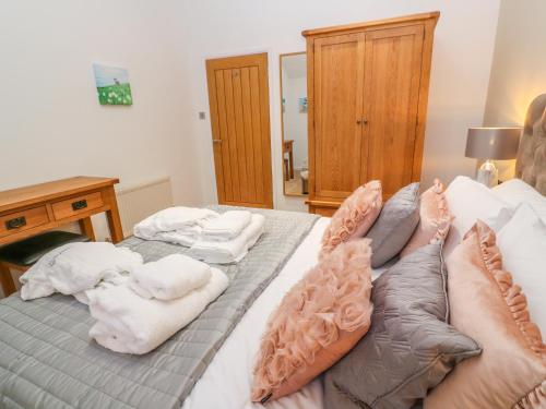 a bedroom with a bed with towels on it at 1 Lake View in Looe