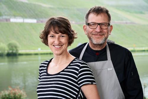 a man and a woman standing next to a lake at Sonnenuhr in Bernkastel-Kues