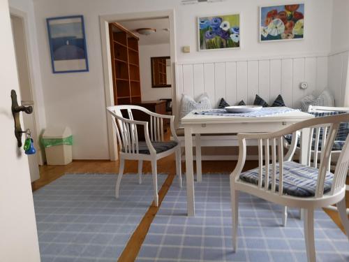 a dining room with a white table and chairs at Stieglerhof KG in Illmitz