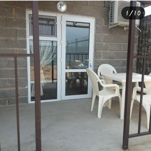 a patio with a table and chairs next to a building at Отдых на Балхаше in Balqash