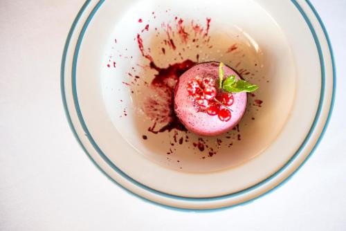 a white bowl with a pink dessert in it at Hotel Isola Sacra Rome Airport in Fiumicino