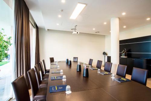 a conference room with a long table and chairs at Hotel Isola Sacra Rome Airport in Fiumicino