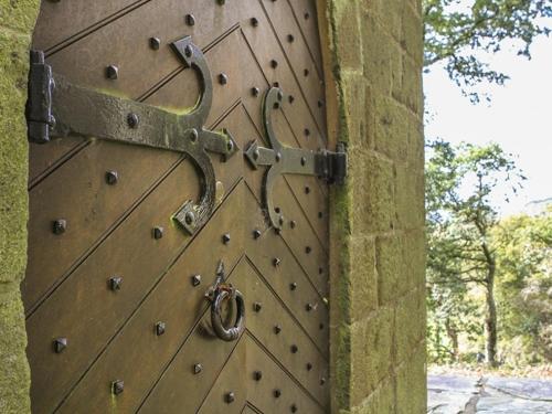 a large metal door with a lock on it at Brynkir Tower in Llanfihangel-y-pennant