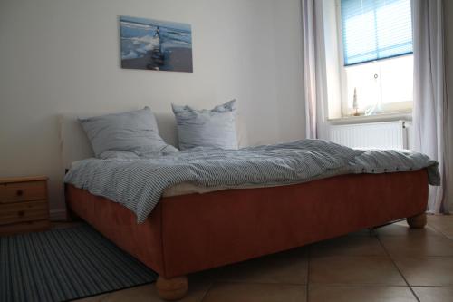 a bed sitting in a room with a window at Ferienwohnung Charlotte in Karlshagen