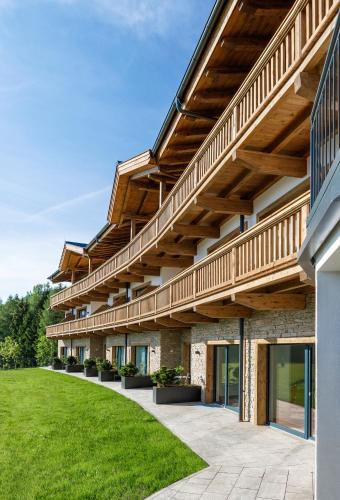 an external view of a building with a green lawn at Leamwirt in Hopfgarten im Brixental
