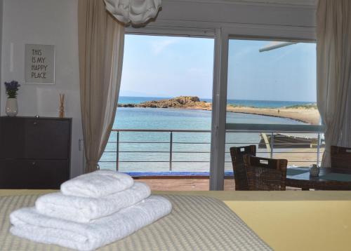 a bedroom with a bed with a view of the ocean at La Casa Azul in Arkoudi