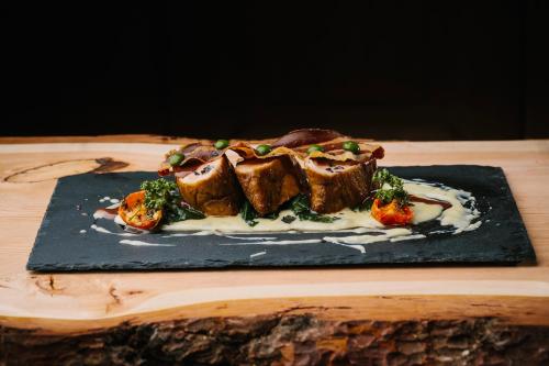 a plate of food on a wooden table at Historic Hotel Albrici in Poschiavo
