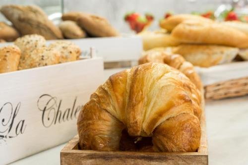 a bunch of croissants and other breads on a table at Hotel Spa Calagrande Cabo de Gata in Las Negras