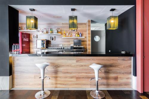 a bar in a restaurant with two bar stools at Hotel Spa Calagrande Cabo de Gata in Las Negras