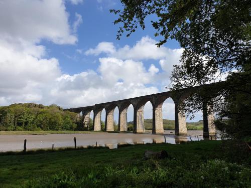 a bridge over a body of water with clouds in the sky at Polborder Holidays Looe Country Park in Looe