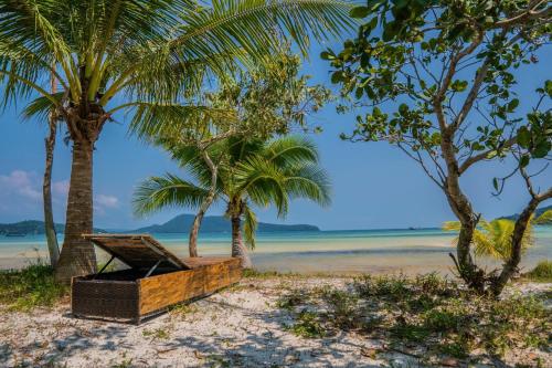 a picnic box on the beach with palm trees at Paradise Villas Koh Rong Sanloem in Koh Rong Sanloem