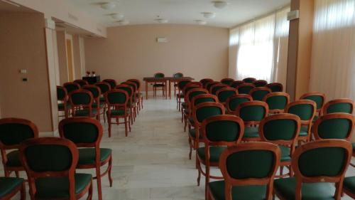 an empty room with chairs and a table in it at Hotel Oasi Dei Discepoli in Orvieto