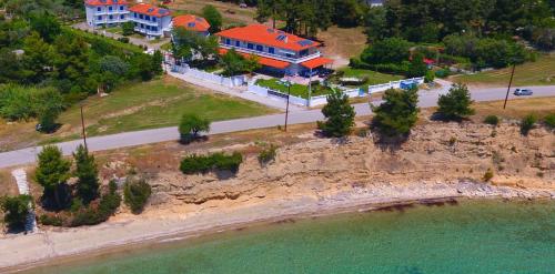 an aerial view of a house next to the ocean at Hotel Paraktio in Nea Kalikratia