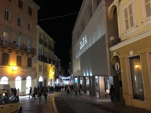 a group of people walking down a street at night at Design Apartments Sassari-Skyline in Sassari