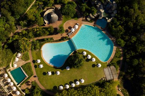 an overhead view of a pool with umbrellas and tents at Arabella Hotel, Golf and Spa in Kleinmond