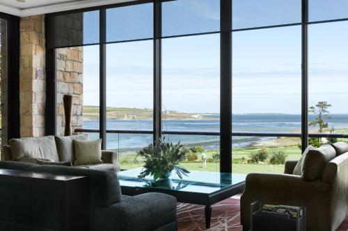 a living room with a view of the ocean at Arabella Hotel, Golf and Spa in Kleinmond