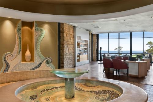 a lobby with a round table and a dining room at Arabella Hotel, Golf and Spa in Kleinmond