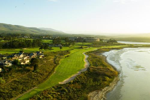 an aerial view of a golf course next to a river at Arabella Hotel, Golf and Spa in Kleinmond