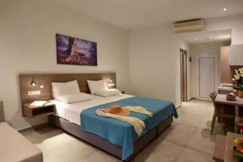 a bedroom with a bed with a hat on it at Blue Horizon Apartments in Balíon