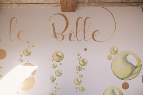 a wall with a be bride sign and bubbles at Ca' Colomba in San Damiano dʼAsti