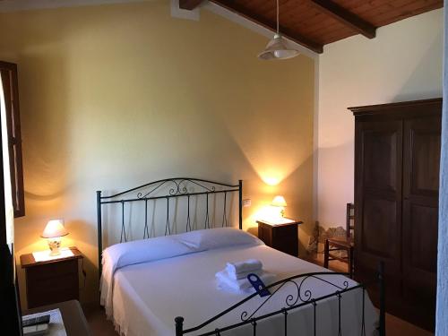 a bedroom with a bed with a teddy bear on it at Hotel Belvedere in Teulada