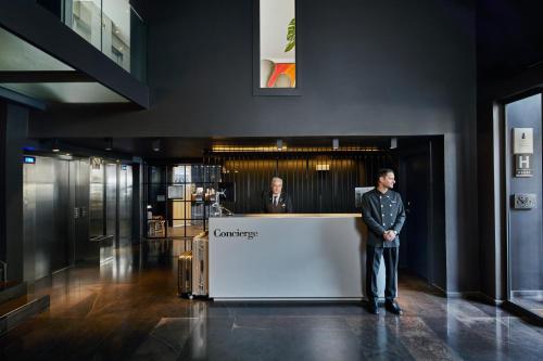 a man standing next to a counter in a lobby at Ohla Barcelona in Barcelona