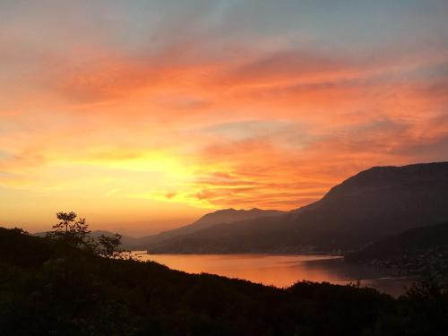 a sunset over a body of water with mountains at Villa Stari Mlin in Herceg-Novi