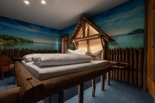 a bedroom with a bed with a painting on the wall at Landgasthof Paradies in Frickingen
