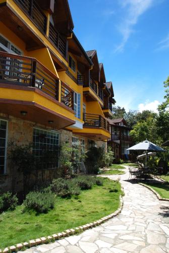 a building with a patio and an umbrella next to a courtyard at Euro Country Villa in Renai