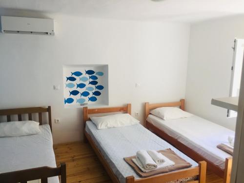 a room with two beds with towels on them at Apartment Chillout House Novalja in Novalja