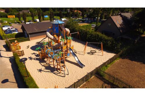 an aerial view of a playground with a slide at Groepsboerderij 20 pers. in Voorthuizen