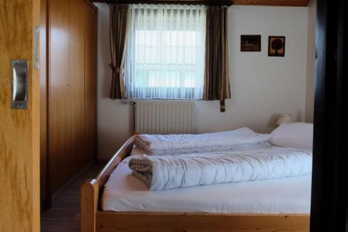 a bedroom with two beds in front of a window at Robinson Crusoe in Waldbrunn