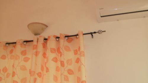 a bathroom with a shower curtain and a light at Appartamento Gioiosa Marea in Gioiosa Marea