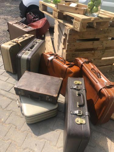 a pile of luggage sitting on the ground at tinyTwice Hotel Wiesbaden in Wiesbaden