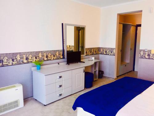 a bedroom with a vanity with a mirror and a bed at Boutique Hotel Royal in Nesebar
