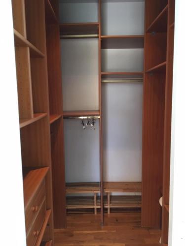 a walk in shower in a room with wooden shelves at Appartements Les Pesquiers 2 Hyères Plage in Hyères