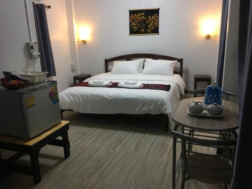 a bedroom with a large bed and a table at T&N home Ayutthaya in Phra Nakhon Si Ayutthaya