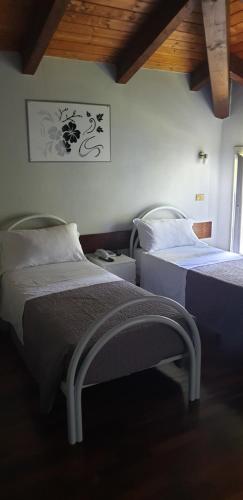 a bedroom with two beds in a room at Hotel Sporting in Campagnola Emilia