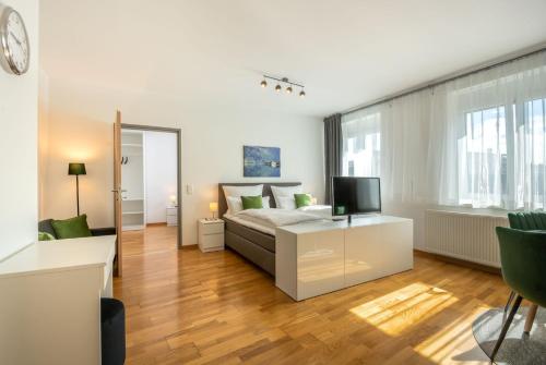 a living room with a bed and a television at City Appartements Villach in Villach
